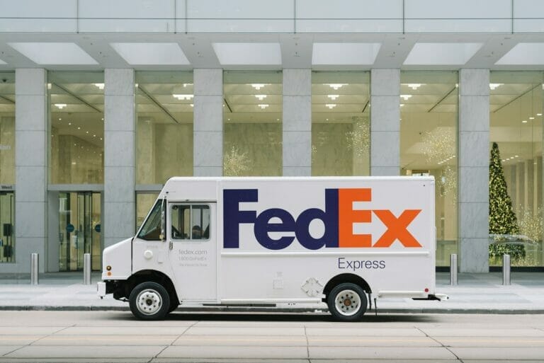 Fedex Express truck parked in front of a building.