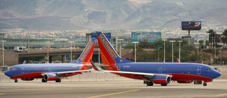 Two airplanes on a runway following Southwest Airlines' pet policy.
